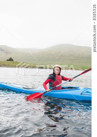 Happy woman in a kayak Happy woman in a kayak 8385316