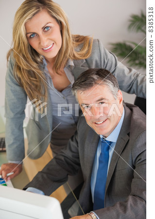Business team in an office looking at camera Business team in an office looking at camera 8385318
