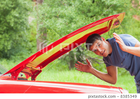 Lost handsome man checking his car engine Lost handsome man checking his car engine 8385349