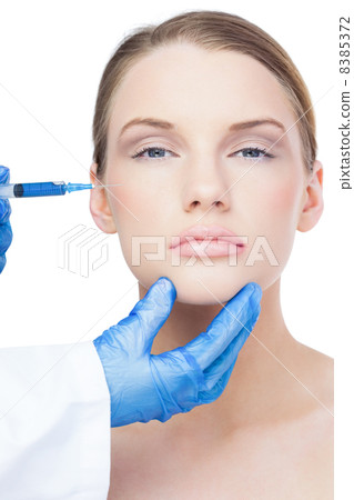 Peaceful attractive model having botox injection on the cheek 8385372
