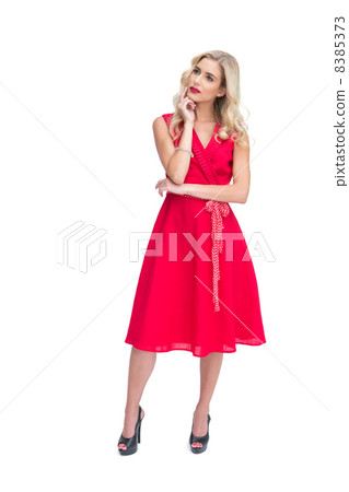 Thoughtful woman posing in red dress 8385373