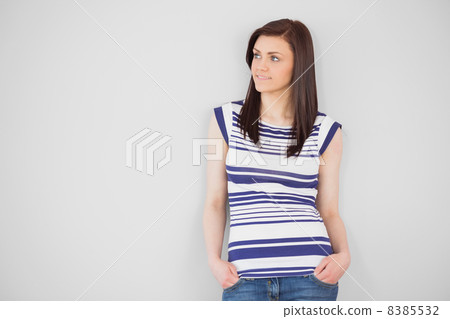 Thoughtful stylish girl standing and looking away 8385532
