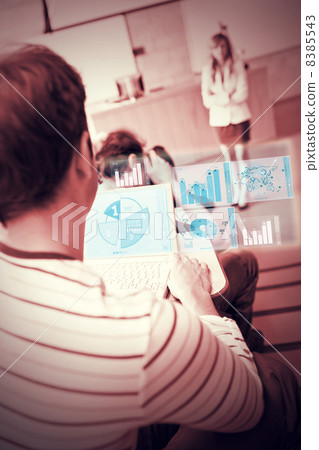 Focused student analysing graphs on his futuristic notebook Focused student analysing graphs on his futuristic notebook 8385543