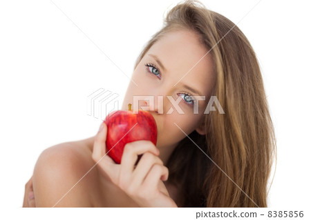 Pensive brunette model eating an apple 8385856