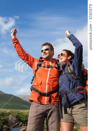 Couple on a hike cheering and smiling Couple on a hike cheering and smiling 8385879