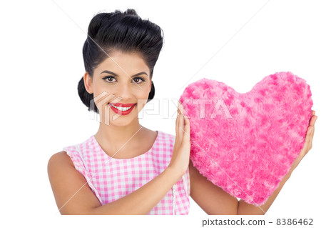 Lovely black hair model holding a pink heart shaped pillow Lovely black hair model holding a pink heart shaped pillow 8386462