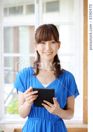 A woman using a tablet PC A woman using a tablet PC 8390470