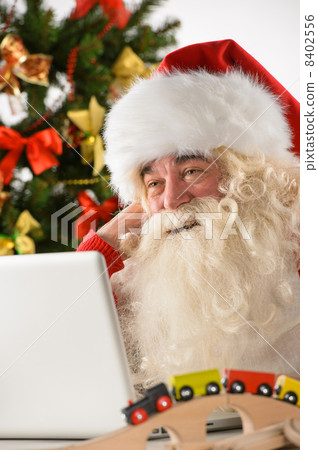 Santa Claus with real beard using laptop Santa Claus with real beard using laptop 8402556