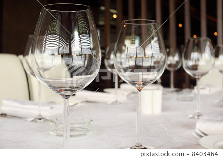 glasses at table with white tablecloth in restaurant; reflection glasses at table with white tablecloth in restaurant; reflection 8403464