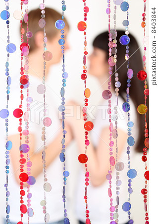 Man and woman dressed in white shirts hold hands and look at eac 8403844