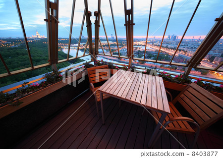 Wooden chairs and table at terrace in restaurant; panorama of ev Wooden chairs and table at terrace in restaurant; panorama of ev 8403877