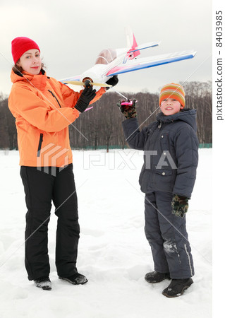 beautiful young mother and young son playing with an airplane at beautiful young mother and young son playing with an airplane at 8403985