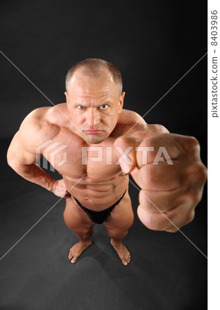 Undressed formidable tanned bodybuilder punches to camera inside 8403986