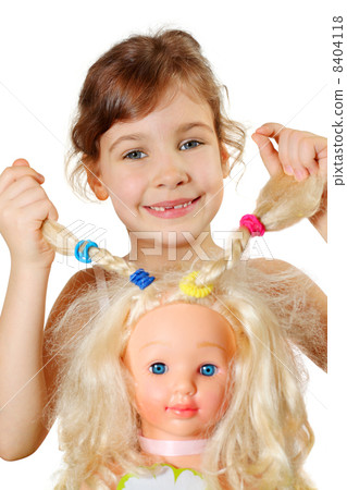 Little girl shows dolls braids, which herself braided isolated o 8404118