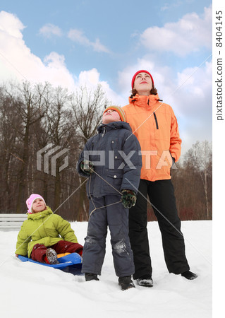 beautiful young mother, little son and daughter standing on snow beautiful young mother, little son and daughter standing on snow 8404145