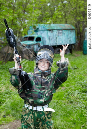Boy in the camouflage suit, with a smile on his face triumphantl Boy in the camouflage suit, with a smile on his face triumphantl 8404149