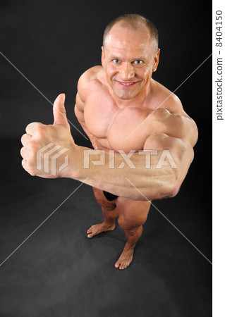 Undressed tanned bodybuilder smiles and thumbs up inside black s Undressed tanned bodybuilder smiles and thumbs up inside black s 8404150