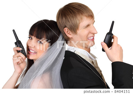 Dissatisfied young groom and bride speak on radio isolated on wh Dissatisfied young groom and bride speak on radio isolated on wh 8404151