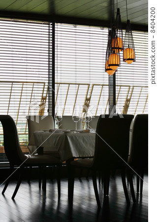 table with white tablecloth and serving and chairs in empty rest 8404200