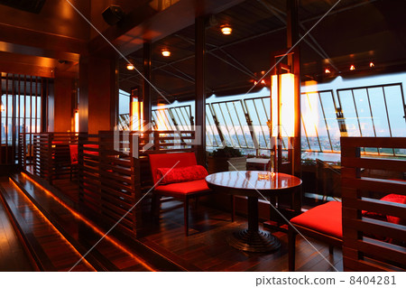 Row of brown tables and red seats with partition-walls in empty 8404281