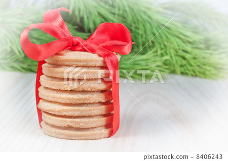 Christmas cookies with a bow. Against the background of the Chri Christmas cookies with a bow. Against the background of the Chri 8406243
