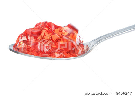 A spoon full of red gelatin. On a white background. A spoon full of red gelatin. On a white background. 8406247