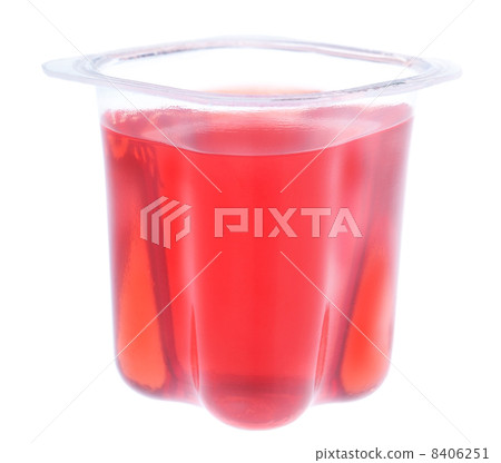 Red gelatin in a plastic yogurt cup. On a white background. 8406251