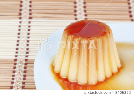 Close-up of yogurt pudding on a plate on decorative wooden napki Close-up of yogurt pudding on a plate on decorative wooden napki 8406253