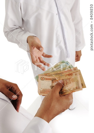 Arabic people, islamic zakat or sadaka, adult giving money to child 8409850