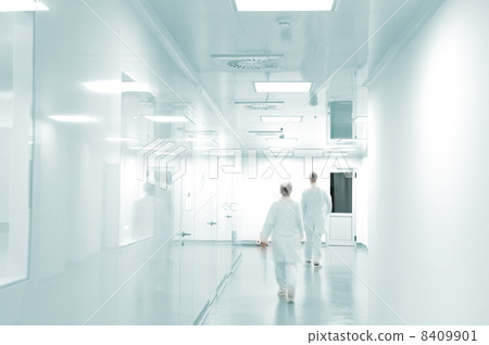 Working people with white uniforms walking in modern factory environment 8409901