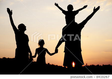 Silhouette, happy children with mother and father, family at sunset, summertime Silhouette, happy children with mother and father, family at sunset, summertime 8410267