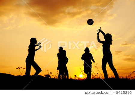 Silhouette, group of happy children playing on meadow, sunset, summertime 8410295