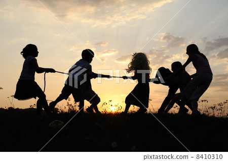 Silhouette, group of happy children playing on meadow, sunset, summertime Silhouette, group of happy children playing on meadow, sunset, summertime 8410310
