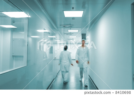 Modern bright factory interior with working people in motion 8410698