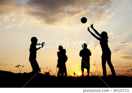 Silhouette, group of happy children playing on meadow, sunset, summertime 8410733