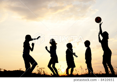 Silhouette, group of happy children playing on meadow, sunset, summertime Silhouette, group of happy children playing on meadow, sunset, summertime 8410931