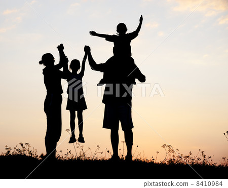 Silhouette, happy children with mother and father, family at sunset, summertime 8410984