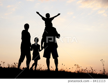 Silhouette, group of happy children playing on meadow, sunset, summertime 8411113