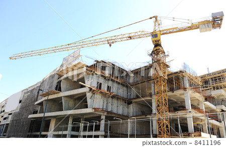 Buildings under construction and cranes under a blue sky Buildings under construction and cranes under a blue sky 8411196