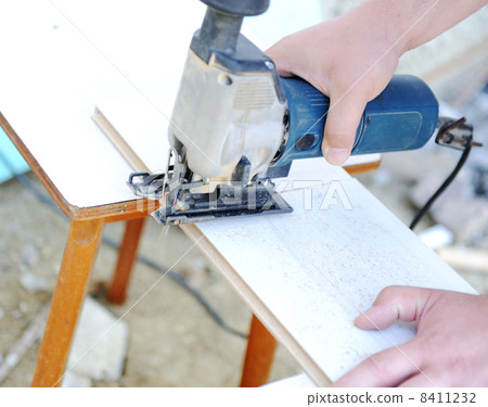 planing a piece of wood trim for a project 8411232