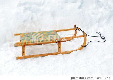 Wooden sled on snow Wooden sled on snow 8411235