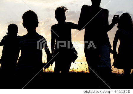Silhouette, group of happy children playing on meadow, sunset, summertime Silhouette, group of happy children playing on meadow, sunset, summertime 8411238