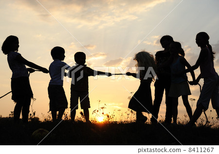 Silhouette, group of happy children playing on meadow, sunset, summertime Silhouette, group of happy children playing on meadow, sunset, summertime 8411267