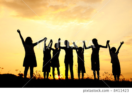 Silhouette, group of happy children playing on meadow, sunset, summertime 8411423