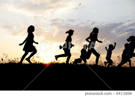 Silhouette, group of happy children playing on meadow, sunset, summertime Silhouette, group of happy children playing on meadow, sunset, summertime 8411606