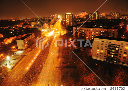 Modern Urban City at Night with Freeway Traffic 8411702