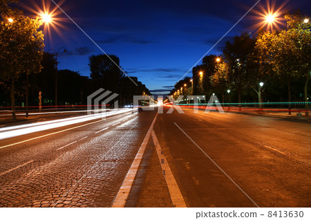 Champs-Elysees avenue at night with the Triumphal Arch in the background, Paris, France 8413630
