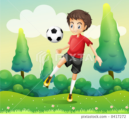 A boy with a red shirt kicking a soccer ball 8417272