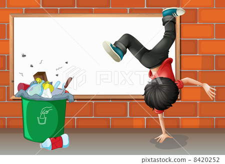 A boy breakdancing near a trash can with an empty board 8420252
