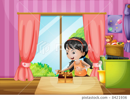 A young girl unwrapping a present inside the house 8421936